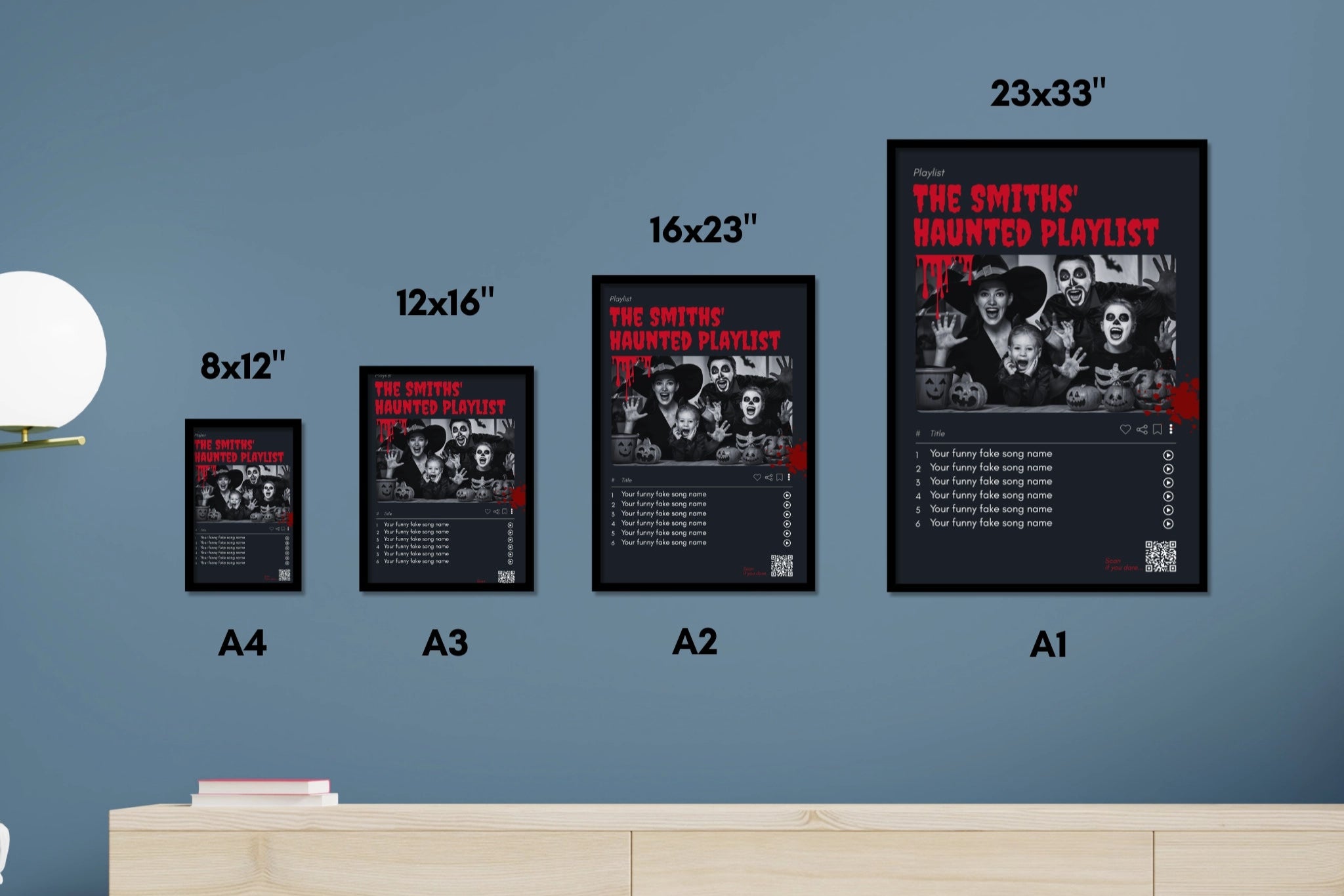Set of framed posters of 'The Smiths' on a wall with a wooden cabinet below.