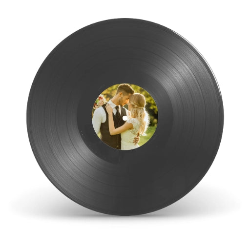 Detailed view of personalized vinyl record center stickers featuring a custom photo of the couple and wedding date.