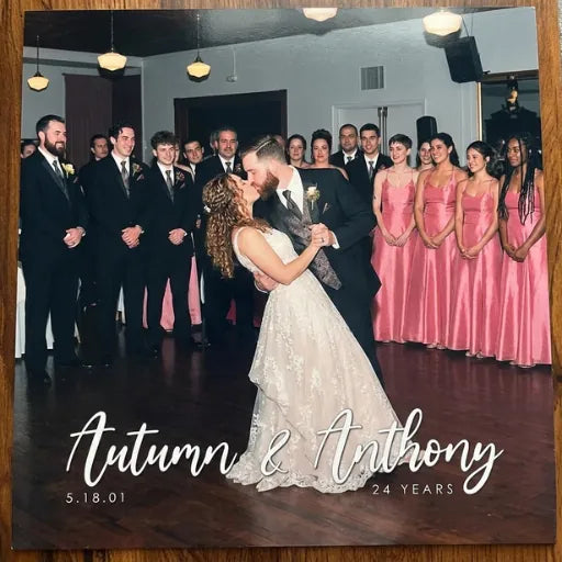 Large-scale photo print on a vinyl jacket featuring a couple's first dance, titled with their names and wedding date.