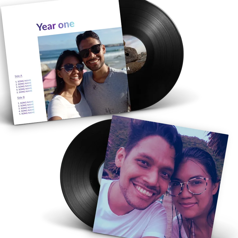 Personalized anniversary vinyl record gift for couples — custom back cover featuring a real couple's photo titled "Year one" with song tracklist on sides A and B, alongside two black vinyl records with couple photos printed on the sleeve.